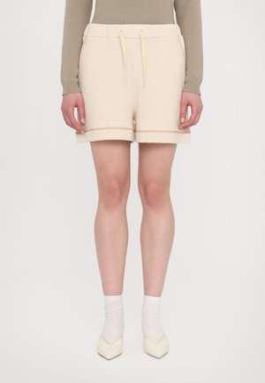 Lys beige bomull-blanding shorts med elastisk midjebånd og snor. Har oppbrettede sømmer med dekorativ brodering. Glatt tekstur.