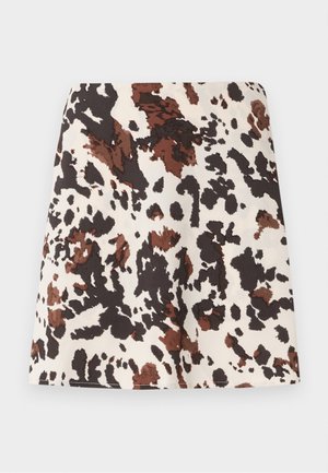 Korte rok met een koeienprint in crème, bruin en zwart. Gemaakt van zachte stof; heeft een rechte, aangesloten pasvorm en een lichte stretch.