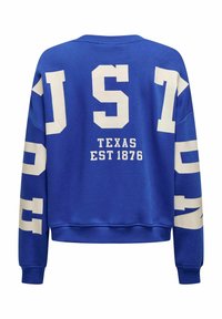 Sweat-shirt bleu avec texte et chiffres blancs. Comprend "JUST" et "TEXAS EST 1876" imprimés dans le dos. Encolure ronde et poignets côtelés.