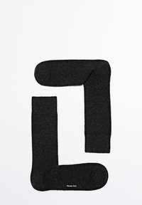 Dark grey socks arranged in a shape resembling the letter "L," featuring a soft texture and ribbed cuffs. Brand logo visible.