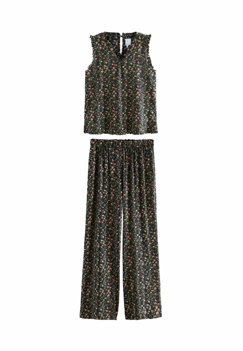 Dvoudílný outfit skládající se z topu bez rukávů a širokých kalhot s elastickým pasem. Temná látka s květinovým vzorem, volánkové ramena, lehký materiál.