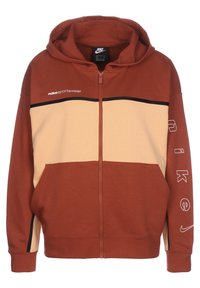 Nike zip-tröja i rost och beige, med en flerfärgad design, mjukt tyg, huva och svarta detaljer med logotyp på ärmen.