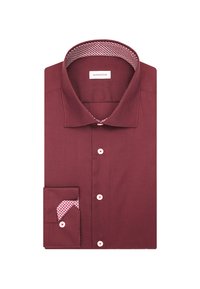 Camicia bordeaux con colletto aperto, bottoni bianchi e una fodera delle maniche e del colletto con un motivo geometrico rosso e bianco.