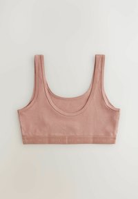 Różowy bawełniany crop top z szerokimi ramiączkami i okrągłym dekoltem. Posiada teksturowaną taśmę z logo "NEXT" na dole. Gładki materiał.