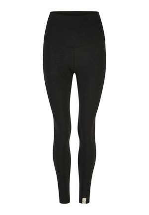 Schwarze Leggings mit hohem Bund, aus elastischem Material, mit einer glatten Oberfläche und einem kleinen Logo-Label am Knöchel.