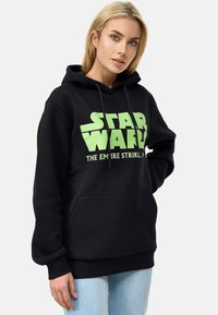 Černá mikina z bavlněné směsi, s zeleným logem a textem "Star Wars", přední kapsou a nastavovací kapucí se šňůrkou.