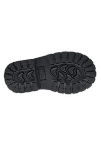 Suela de zapato de goma negra con una superficie texturizada, que presenta surcos profundos y un patrón de formas curvas para agarre y tracción.