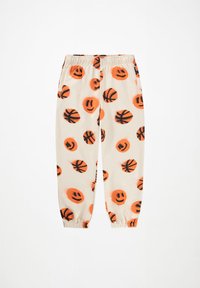 Lysecreme joggers med sort og orange smiley-ansigt og basketball mønstre. Elastisk talje og manchetter i bunden for en sikker pasform.