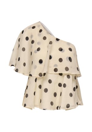 Μπλούζα σε κρεμ χρώμα με έναν ώμο, στρωματοποιημένες βολάν και μεγάλες μαύρες πουά.