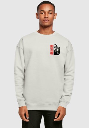 Light gray sweatshirt made of fleece with a ribbed neckline and cuffs. Features a graphic print with a ghost and red text stating "NO YOU HANG UP."
