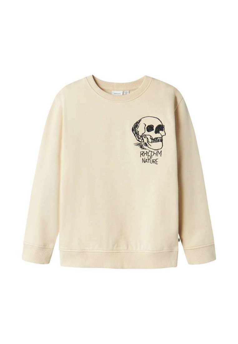 Sweatshirt beige en tissu doux, ornée d'un graphique de tête de mort noire et du texte "RYTHME DE LA NATURE" sur le côté gauche de la poitrine. Encolure ronde et poignets côtelés.