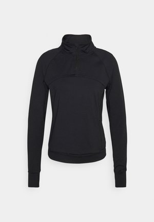 Schwarzes, langärmliges Sportoberteil mit einem halben Reißverschluss am Kragen, weichem Textil, enganliegendem Design und flachen Nähten, das über eine Paneeldetailierung auf der Brust verfügt.