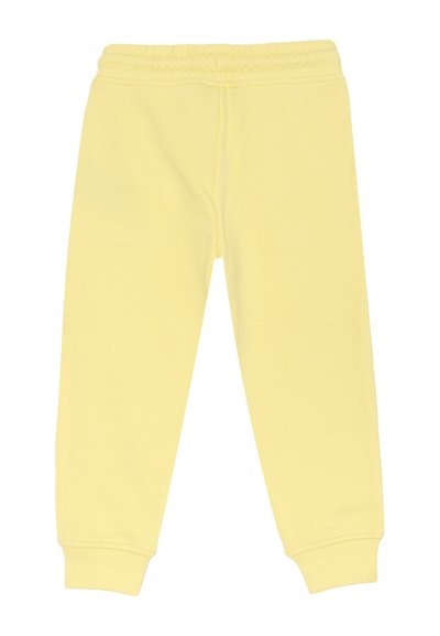 Pantaloni sportivi per bambini di un morbido giallo, con vita elasticizzata e polsini a costine, presentati distesi su uno sfondo bianco.