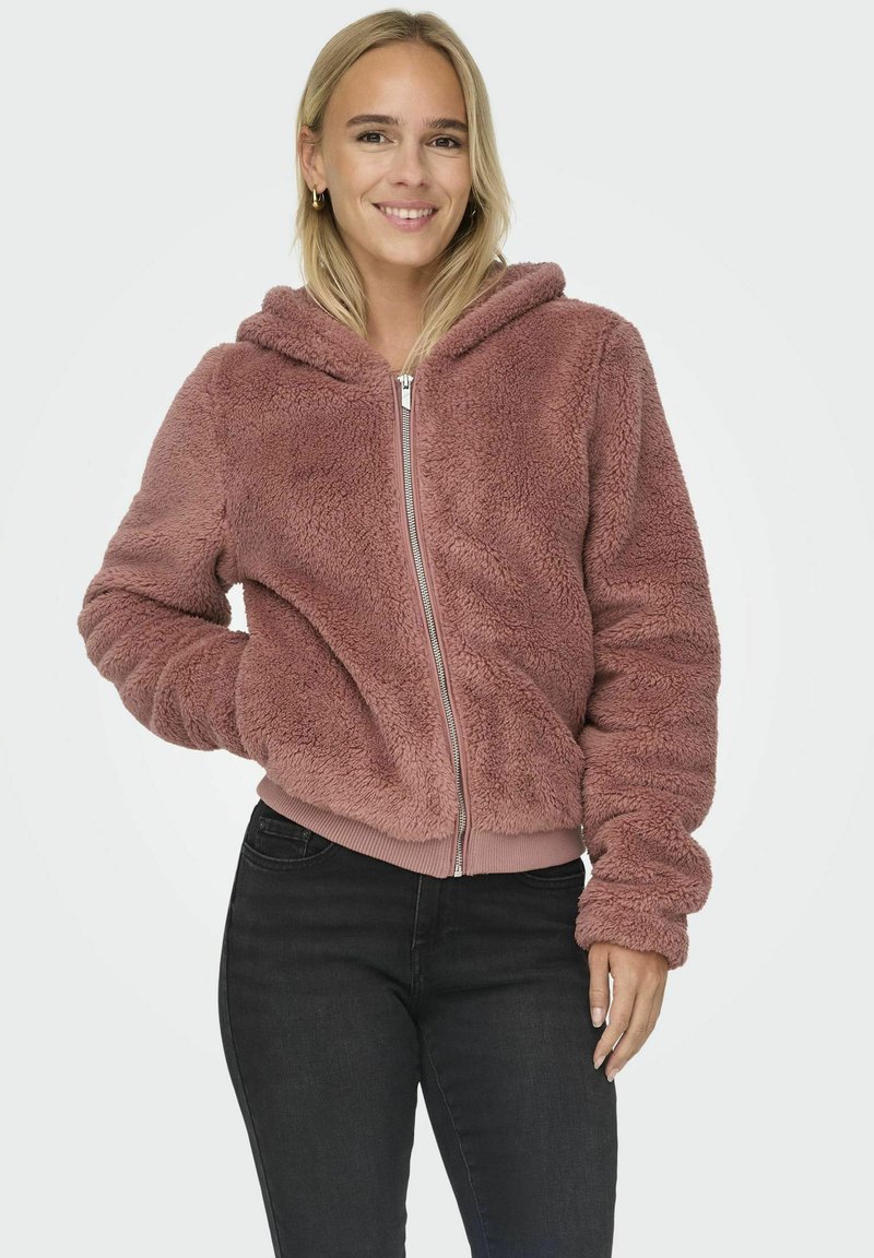Flauschige, pinke Kapuzenjacke mit Reißverschluss, elastischen Bündchen und Saum. Sie hat eine weiche Textur und ein leicht verkürztes Design.
