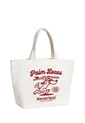 Cream-colored tote bag with a red cartoon dog carrying a surfboard and text "Palm Locos," "Wave Lovers Club," and "Neverless catch me at the beach."