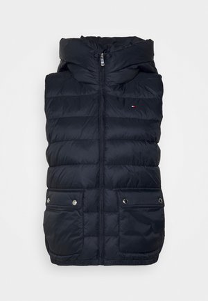 Donkerblauwe gewatteerde mouwloze bodywarmer met voorrits, hoge kraag, twee klepzakken met drukknopen en klein vlaglogo op de borst.