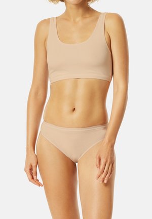 Beige seamless bralette and matching panties made of soft, stretchy fabric. The design features a scoop neckline and a low-rise waistband.