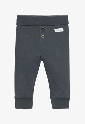 Ciemnoszare legginsy z mieszanki bawełny z prążkowanym pasem w talii, dwoma drewnianymi guzikami z przodu oraz dopasowanymi mankietami. Obecne są subtelne detale przeszycia.