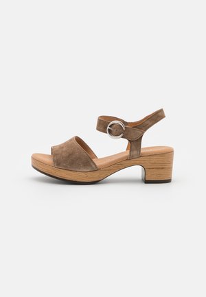 Suede open-toe sandals in brown with a buckle ankle strap, a 5 cm wooden block heel, and a textured platform for stability.