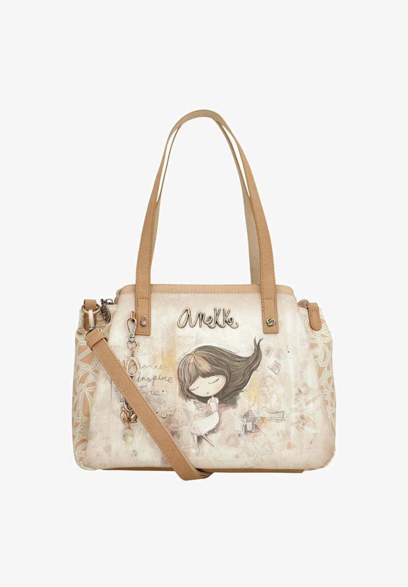 Beige handbag with a printed girl illustration, metal hardware accents, and dual straps. Features a patterned side panel and charm detail.