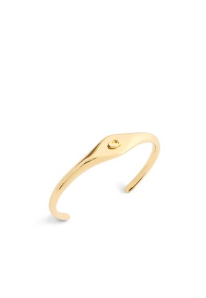 Gold-toned metal cuff bracelet featuring a smooth and sleek design, with an elegant curve and a small decorative detail at the top.