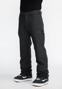 Black waterproof snow pants with a straight fit, zippered pockets, and a subtle logo. Textured fabric and reinforced seams for durability.