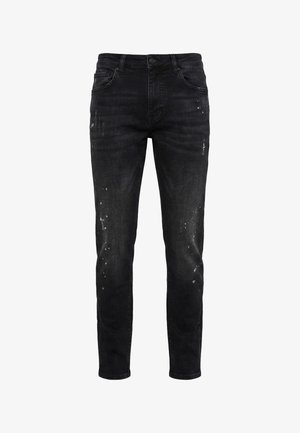 Musta slim fit -farkut haalistuneilla alueilla ja pienillä valkoisilla maalitahroilla, viiden taskun malli, napillinen suljentaja ja vyölenkit.