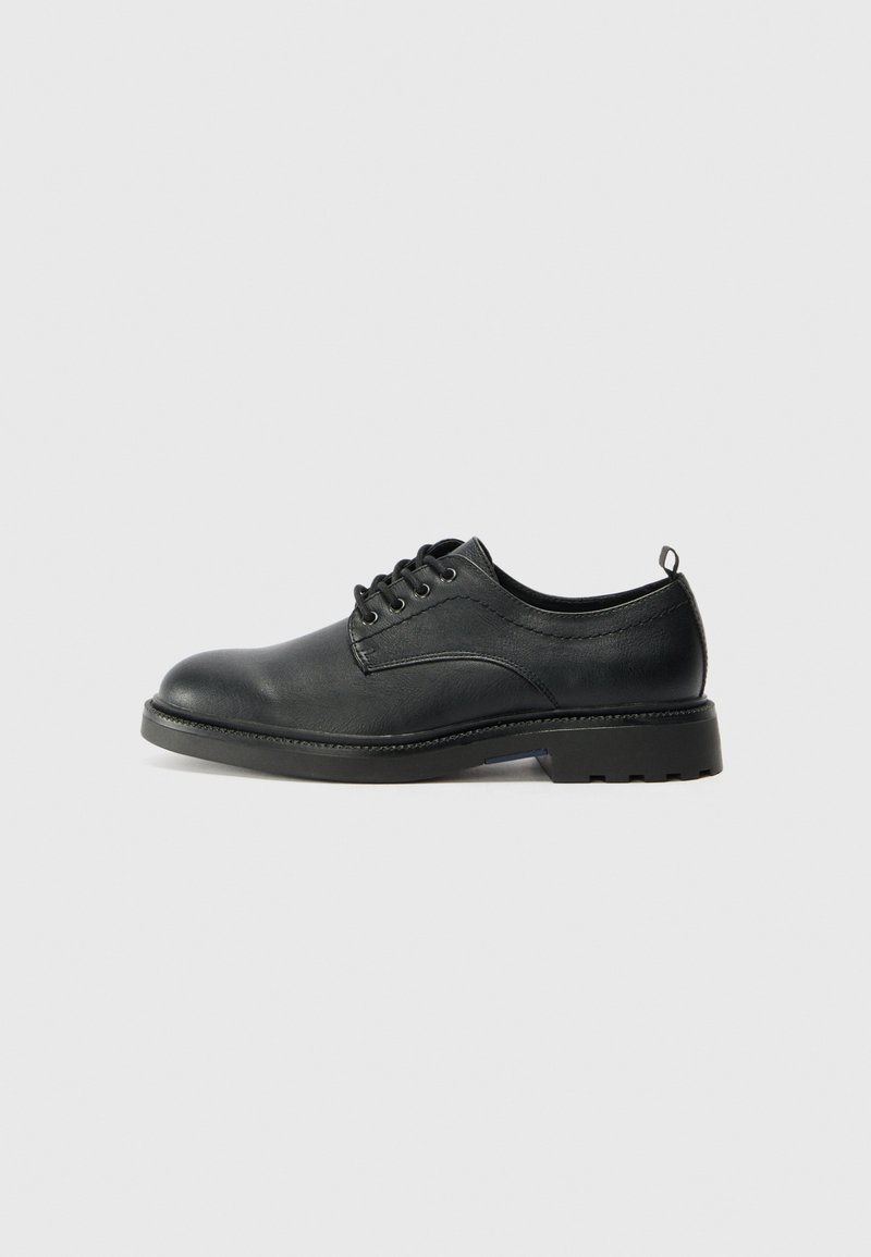 Black leather oxford shoe with rounded toe, lace-up design, textured upper, and a sturdy rubber sole featuring small treads.