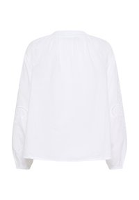 White long-sleeve blouse featuring a round neckline, gathered back, and intricate embroidered detailing on the sleeves. Made of lightweight fabric.