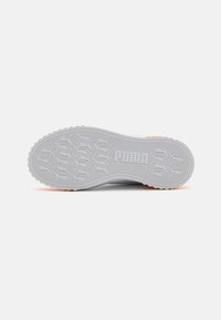 Gray rubber shoe sole with traction patterns and pink accents. Features a textured surface and molded branding in the center.