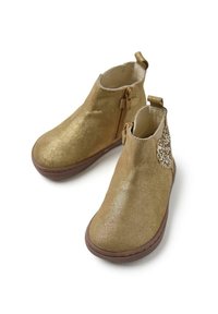 Botines de tobillo dorados con purpurina, cierre lateral, punta redonda y acabado texturizado. Presentan un acento decorativo de tela en el tacón.