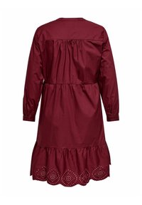 Burgundy long-sleeve dress with a gathered waist, ruffled hem, and embroidered detailing along the bottom hem. Made from lightweight fabric.