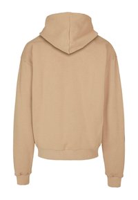 Beige hættebluse med en afslappet pasform, ribbede manchetter og søm, der har en glat tekstur og set fra ryggen. Ingen synlige logoer eller mønstre.