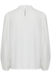 Blusa bianca a maniche lunghe con apertura a chiave sul retro, texture morbida e maniche a sbuffo arricciate, con chiusura a bottone al collo.
