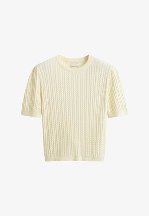 Roomkleurige korte mouw kabelgebreide trui met ronde hals en geribbelde zoom en manchetten, voorzien van een klein label aan de binnenkant van de kraag.