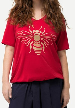 Red short-sleeve T-shirt with a golden bee graphic on the front. The fabric appears soft, and the shirt has a V-neck design.