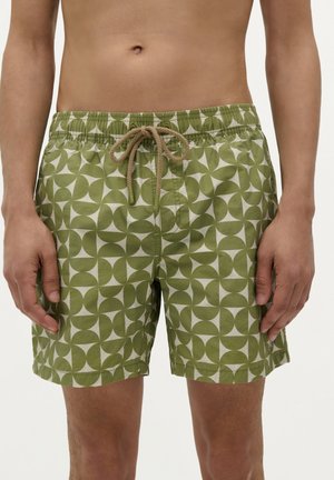 Grüne gemusterte Badeshorts mit einem geometrischen Design aus Kreisen und einem Kordelzug mit beigen Bändern. Leichtes Material, elastischer Taillenbund.