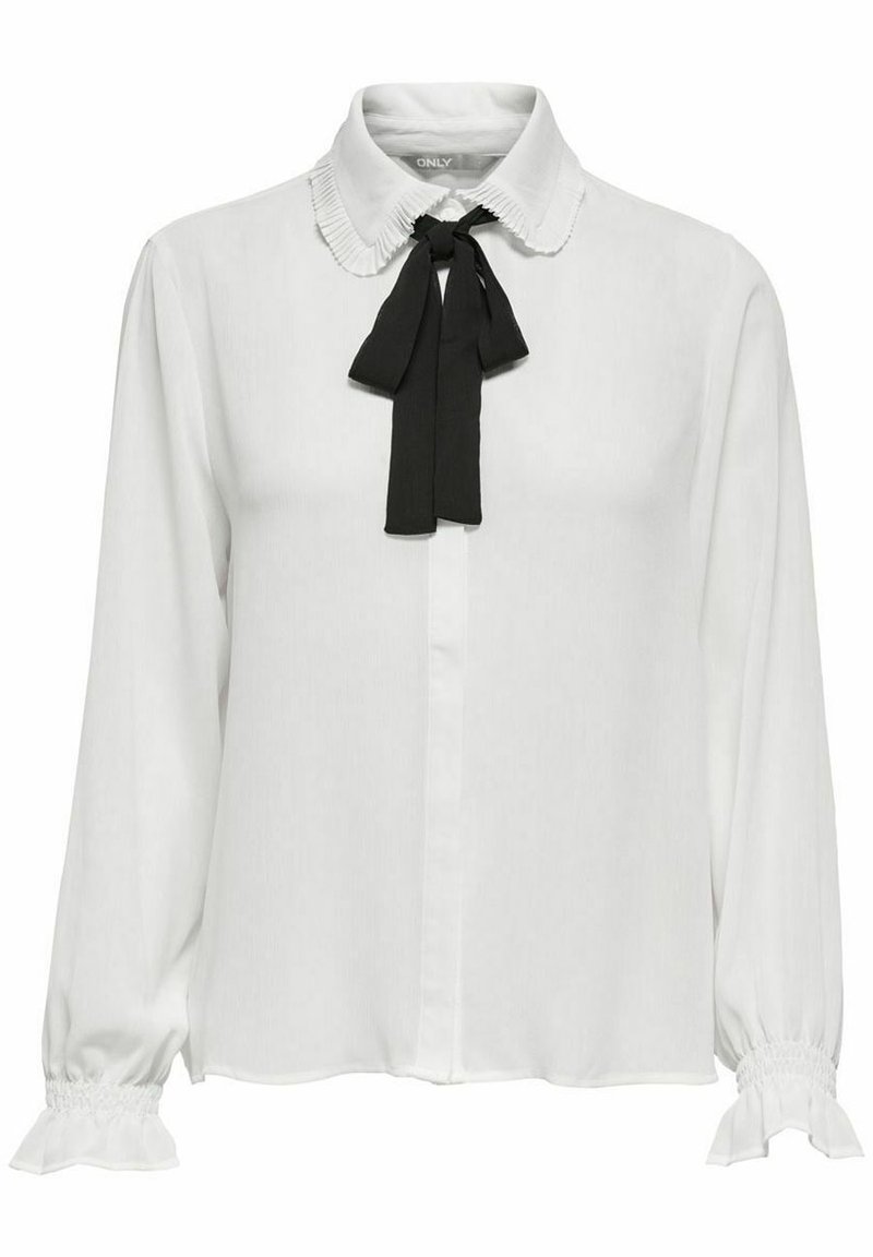 Blouse blanche avec un col côtelé et un nœud papillon noir. Manches longues avec poignets froncés. Tissu lisse avec une patte de boutonnage à l'avant.