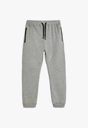 Grijze joggingbroek met elastische tailleband en trekkoord. Zipper aan de zijkanten en textuuraccenten op de onderbenen. Zachte, rekbare stof.