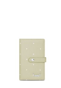 Green faux leather wallet with white polka dots, featuring a snap closure and silver logo accent at the bottom. Smooth texture.