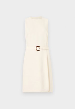 Sleeveless ivory dress with round neckline and belted waist featuring a tortoiseshell buckle, knee-length skirt with subtle wrap detail.