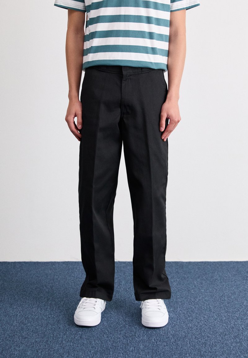 Black pants with a straight-leg design, featuring a smooth texture and clean lines, paired with a horizontally striped teal and white shirt.