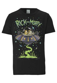 Black T-shirt featuring a cartoon design of two characters in a spaceship, with green swirling liquid and colorful planets in the background.
