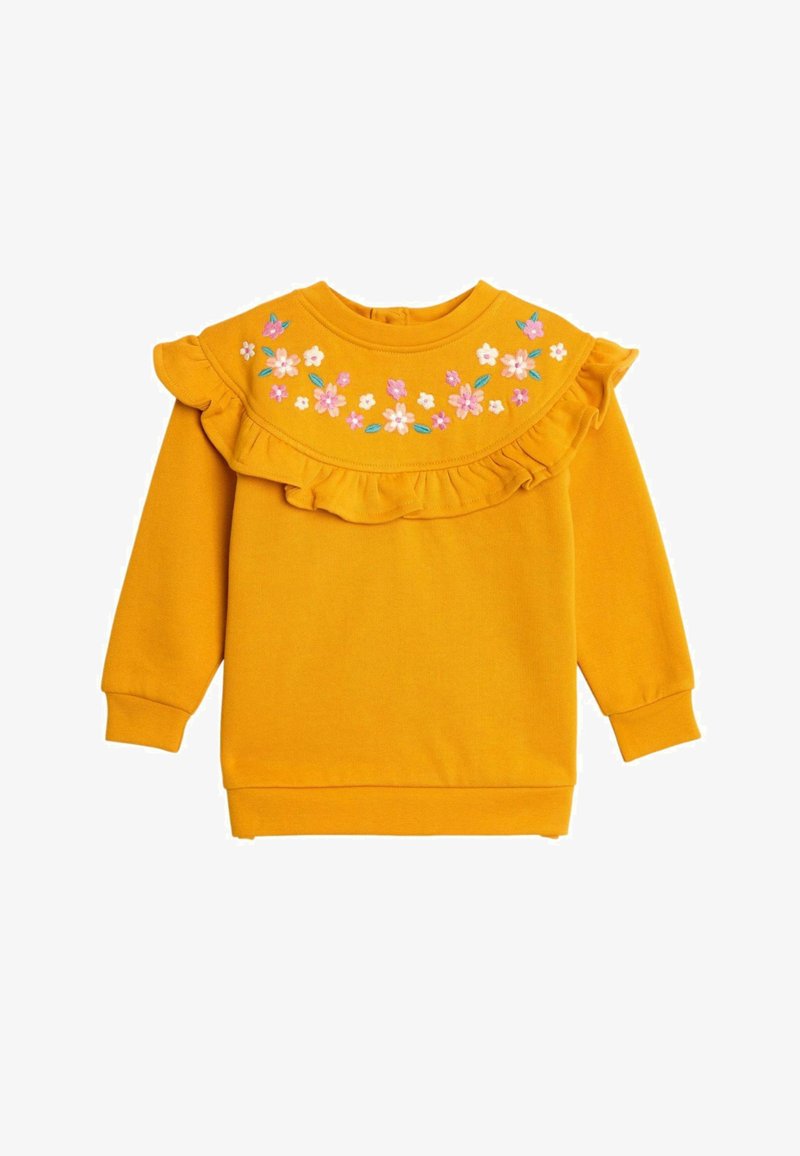 Sárga pulóver, hímzett virágmintával, fodros nyakkivágással, hosszú ujjakkal és bordázott mandzsettákkal. Puha tapintású és laza szabású.