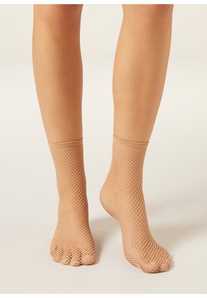 Beige fotnätsstrumpor till ankeln med öppen tå, texturerat diamantmönster, elastisk mudd och genomskinligt material som täcker underbenen.