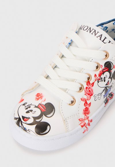 White sneaker with lace-up closure, featuring colorful Mickey Mouse and floral patterns. Textured rubber sole and gold eyelets.