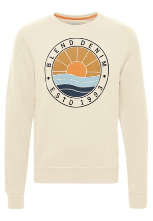 Cremefarvet sweatshirt med et cirkulært grafisk design, der viser en solnedgang og bølger i orange, blå og marineblå. Ribbet på ærmer og kant.