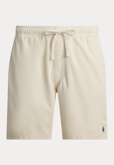 Μπεζ ανδρικά σορτς με ελαστική μέση και κορδόνι, με μικρό σκοτεινό λογότυπο στο κάτω αριστερό πόδι.