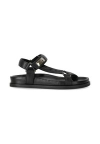 Sandal in pelle nera con suola piatta, cinturino alla caviglia regolabile e una piastra metallica accentata sul davanti. Design minimalista con punta aperta.