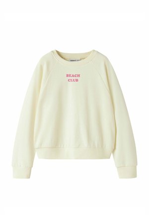 Kremowa bluza z długim rękawem i okrągłym dekoltem, z prążkowanymi mankietami i dołem, z różowym napisem "BEACH CLUB" na środku klatki piersiowej.